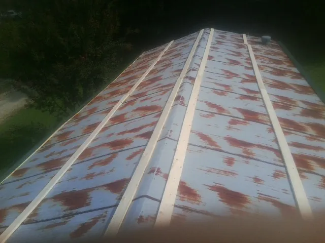 Rusted metal roof panels with new wood purlins before replacement — Storm Damage Roof Repair in Crystal Springs by Roofing Brothers
