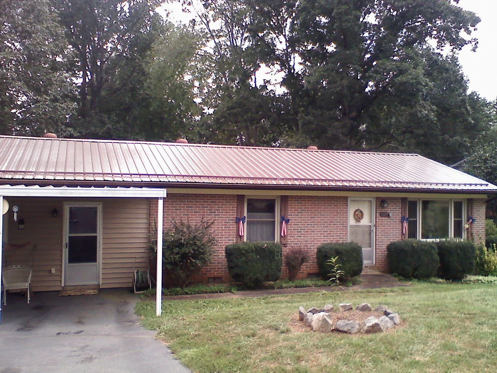 Bronze metal roof and carport on a brick ranch home — Roof Repair work by our crew in Crystal Springs