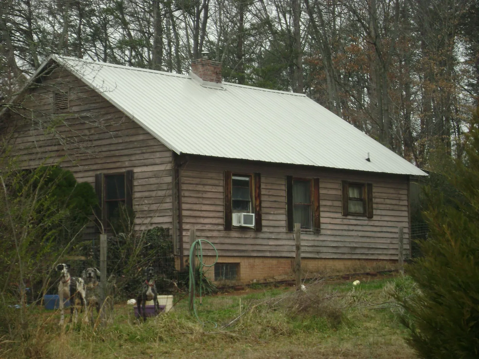 White metal roof on an old wood sided farmhouse, from a Metal Roof Installation job in Crystal Springs
